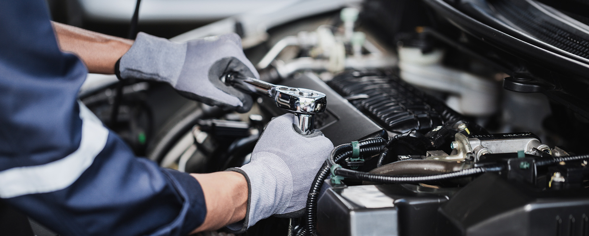 man repairing car in collision center